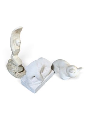 two sculptures that are sitting next to each other on a white surface