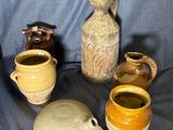 many different types of vases sitting on a blue cloth