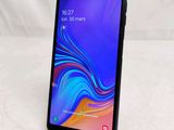 a close up of a black samsung galaxy j5 smartphone on a white surface