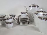 many cups and saucers sitting on a table