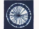 tie - dyed blue and white rug with a circular design in the middle