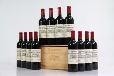 six bottles of red wine in a wooden box on a white surface