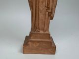 statue of a man in a robe with a book in his hand
