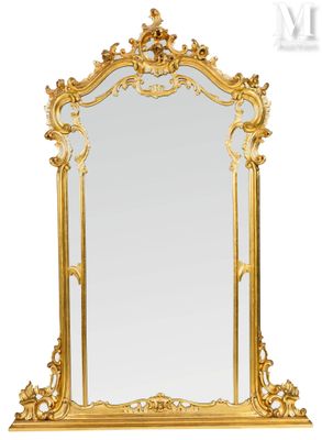 a large gold mirror with a decorative frame on a white background