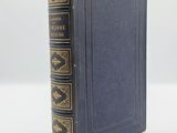 a blue book with gold trim and a black cover