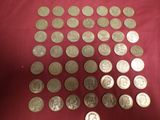 a lot of coins that are on a red cloth