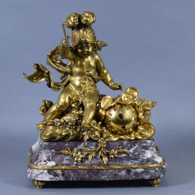 a gold statue of a woman sitting on a marble base