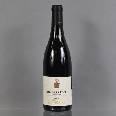 a bottle of wine sitting on top of a glass table