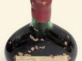 a black bottle with a red lid and a label on it