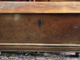 an old wooden chest sitting on top of a rug in a room