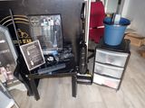 a table with a camera, a camera case, and other items on it
