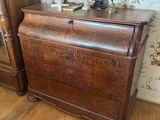 a wooden chest with a lamp on top of it