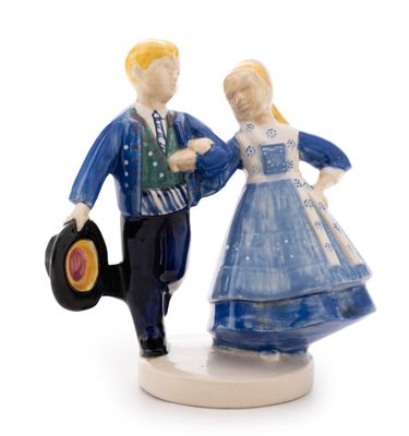 a figurine of a man and a woman holding a record