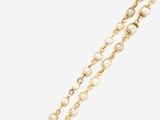 a close up of a necklace with pearls on a white background
