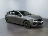 the grey car is parked in a white room with a black floor