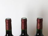 three bottles of wine that are sitting on a table