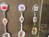 a picture of a collection of spoons and spoons on display in a glass case