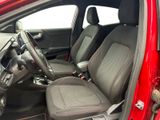 the interior of a red car with black seats and a steering wheel