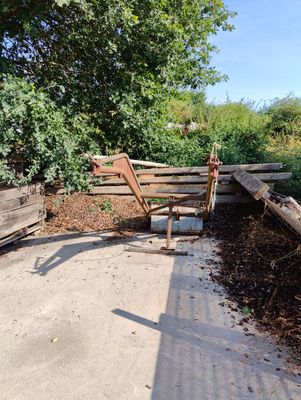a wooden bench sitting on the side of the road