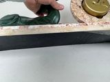 a person that is cutting a piece of wood with a knife