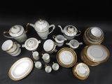 many different types of porcelain dishes and cups on the table