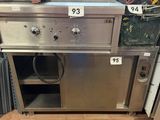 a person ' s feet on the floor in front of a stove