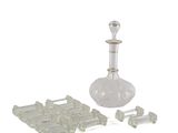 a glass decanter and a set of pieces of glass