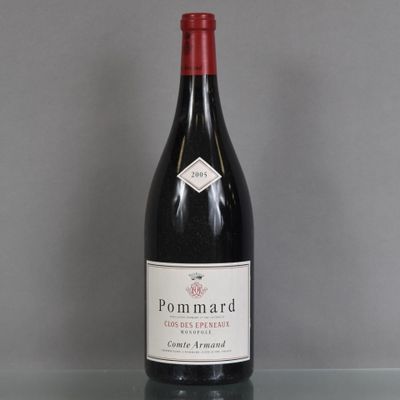 a bottle of wine sitting on top of a glass table