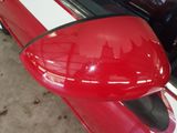a red car with a white stripe on the side of it