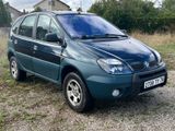 a picture of a small blue car parked in a field