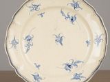 a blue and white plate sitting on a wooden table