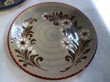 a plate with a flower design on it on a table