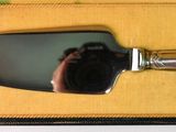 a small mirror that is in a box with a silver handle