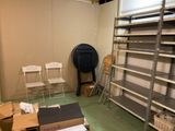 a room that has a lot of shelves and chairs in it