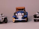 three toy cars sitting next to each other on a table