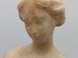 marble statue of a woman with her hands on her chest