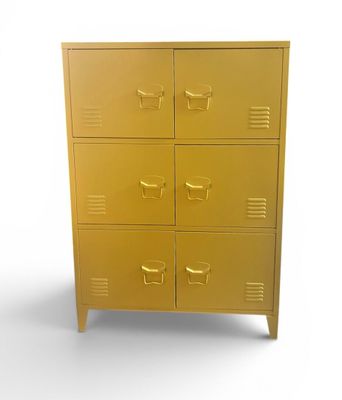 a gold metal cabinet with five drawers and a cup on top