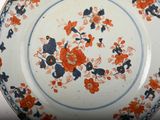 a plate with a floral design on it sitting on a table