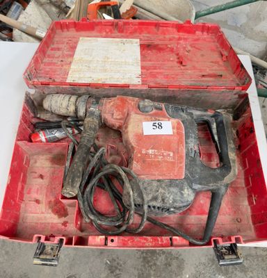 une boîte à outils rouge contenant un marteau et d'autres outils
