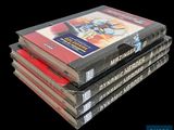 four books stacked on top of each other on a black background