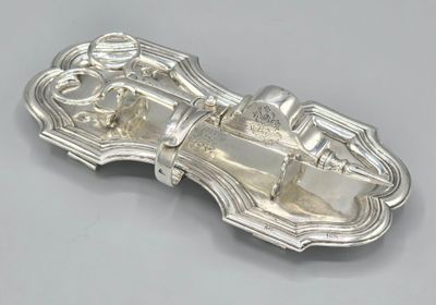 an antique silver plate with a horse and carriage design on it