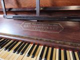 a piano that has a sign on it that says kregelstein ' s piano