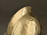 a close up of a metal helmet on a table