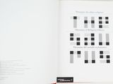 a person holding a book open to a page with black and white squares on it