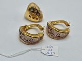 two pairs of gold earrings and a gold ring on a white surface