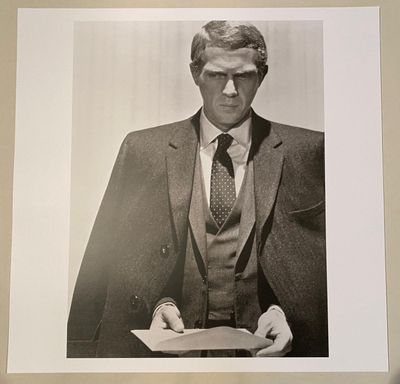 a black and white photo of a man in a suit and tie
