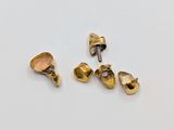 three pieces of gold colored metal are sitting on a white surface