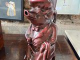 un vase rouge sur lequel est représenté un singe