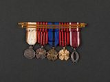 a close up of a medal and a pen on a black surface