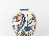 a vase with a floral design on it on a white surface